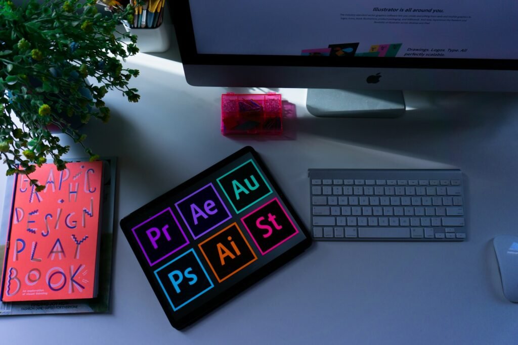 Graphic design workspace with a tablet showing visual design software